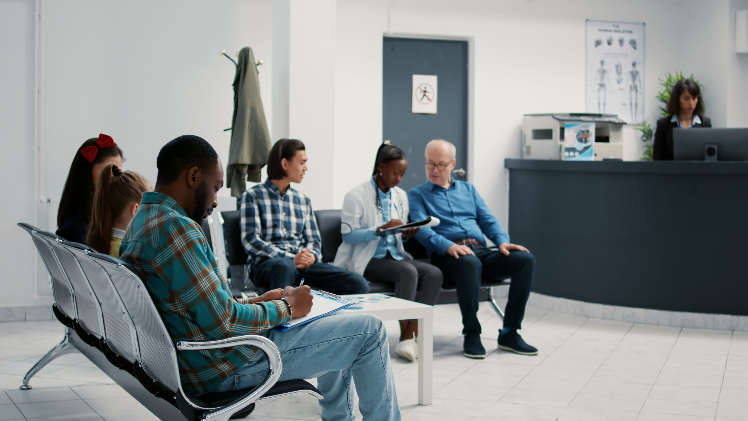 Diverse group of patients sitting in waiting room at hospital people in a hospital waiting room